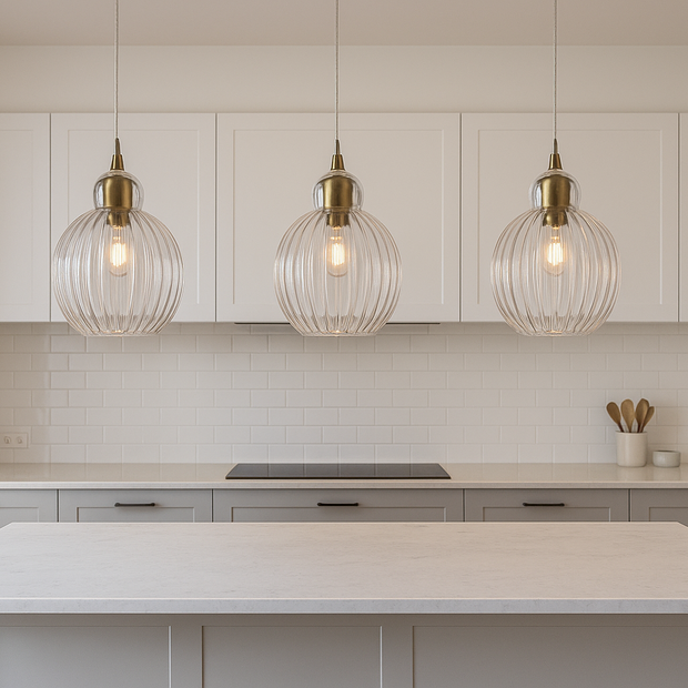 Modern kitchen with white island, pendant lights, and neutral color scheme.