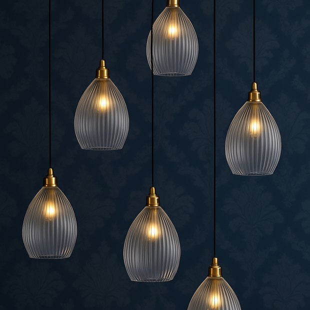 Set of six glass pendant lights with gold fixtures on a dark blue background.