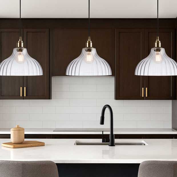 Modern kitchen with dark wood cabinets, white countertops, and pendant lights.