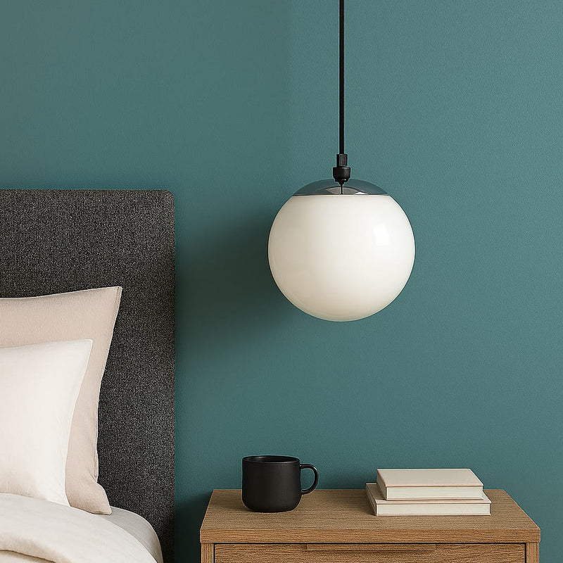 Modern bedroom with a white pendant light, wooden nightstand, and teal wall.